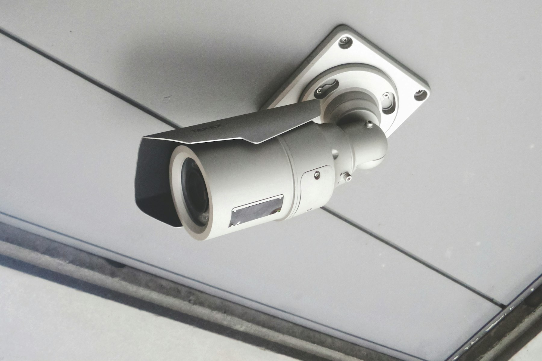 Outdoor security camera mounted under a building soffit